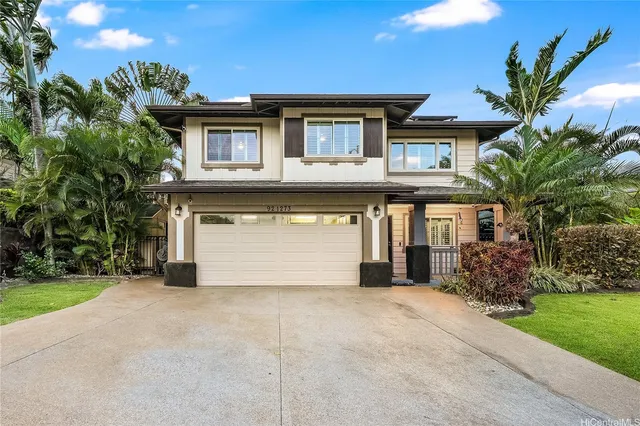 a front view of a house with a garden and plants