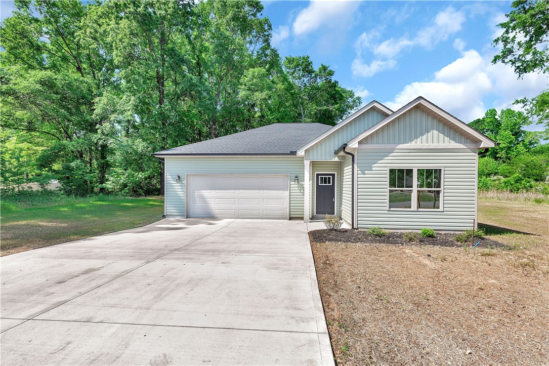 112 Brookridge Drive Anderson, SC 29624 - Photo 21 of 27 This charming home offers a convenient garage and a well-maintained exterior amidst lush greenery.