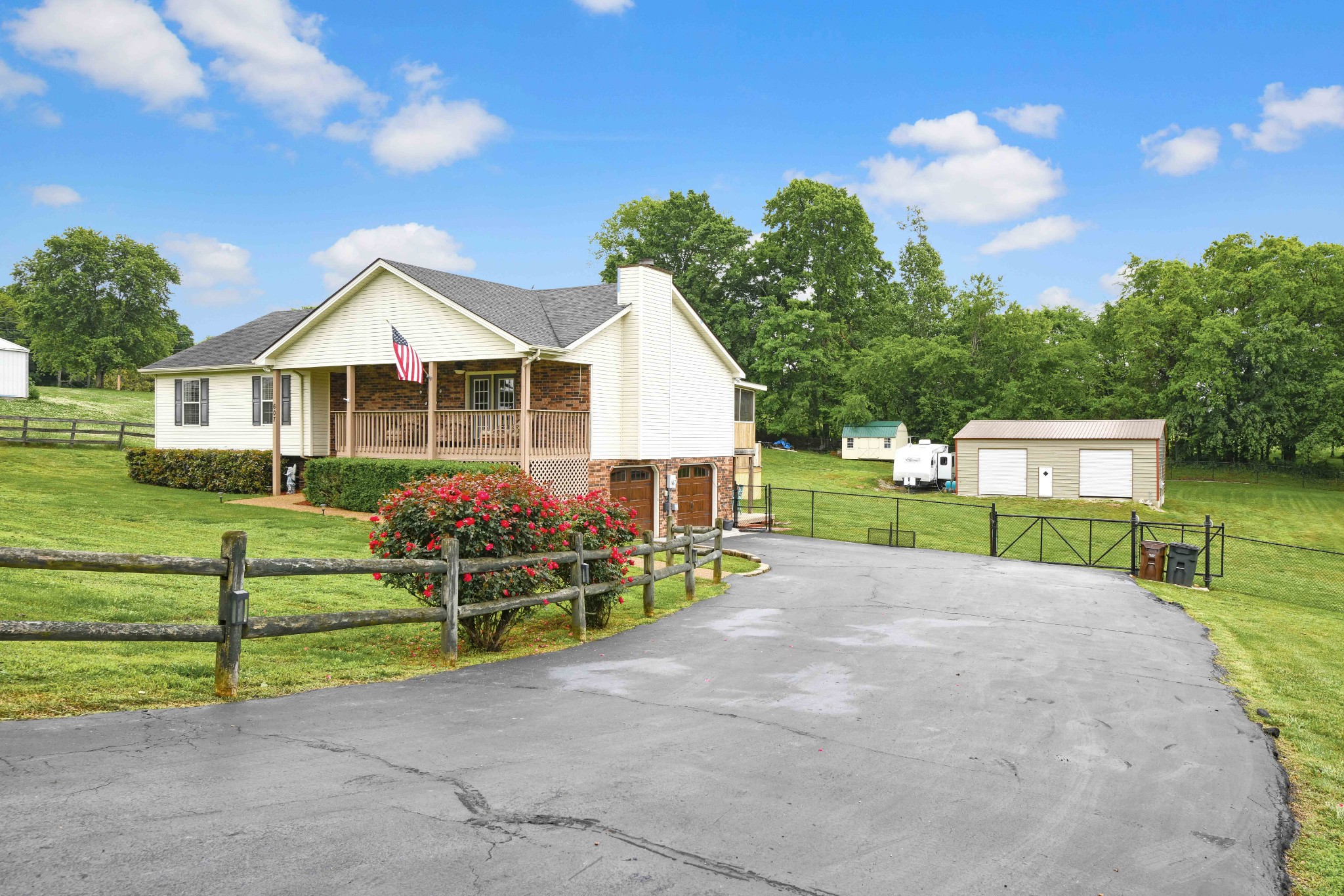 607 Vaughan's Gap Road Spring Hill, TN 37174 - Photo 1 of 34 a front view of a house with a yard and trees