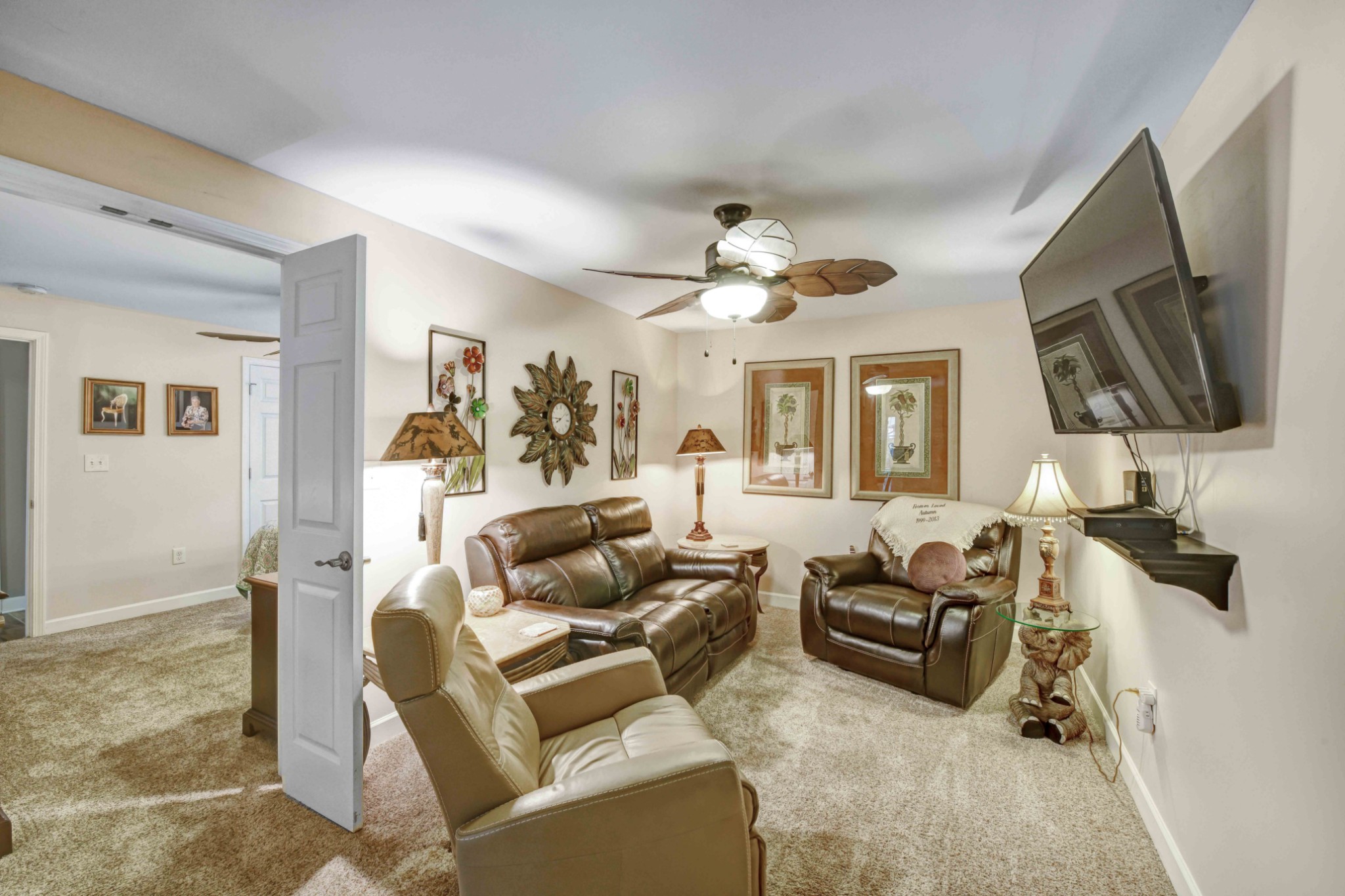 607 Vaughan's Gap Road Spring Hill, TN 37174 - Photo 18 of 34 a living room with furniture a chandelier and a flat screen tv