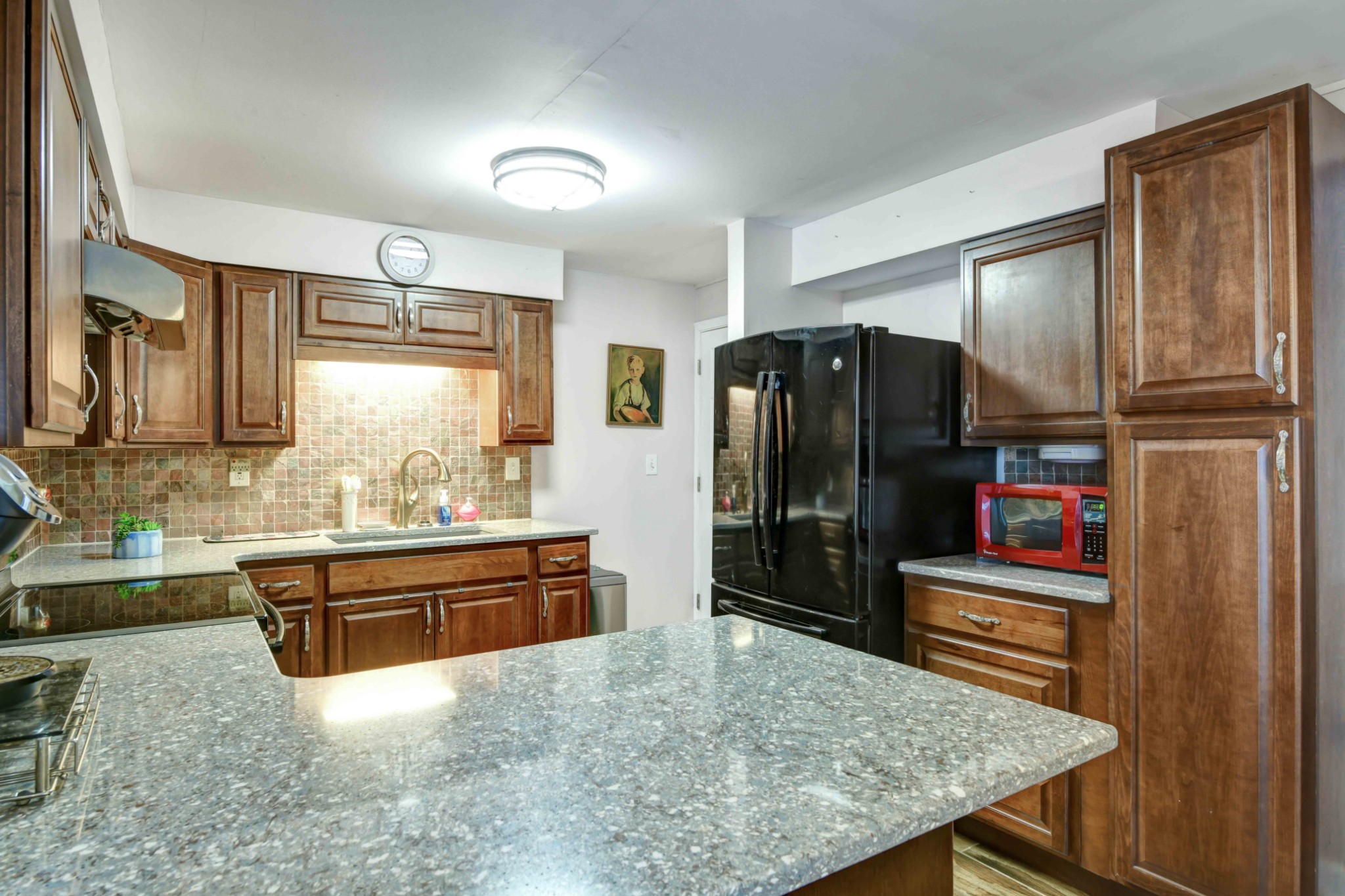 607 Vaughan's Gap Road Spring Hill, TN 37174 - Photo 19 of 34 a kitchen with stainless steel appliances granite countertop a refrigerator and a stove top oven