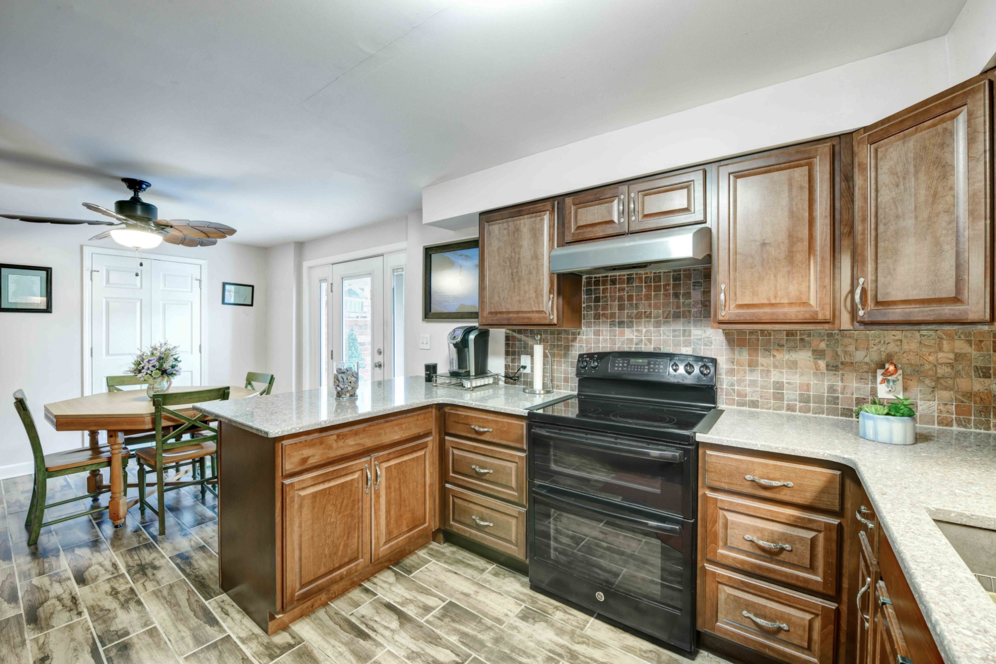 607 Vaughan's Gap Road Spring Hill, TN 37174 - Photo 20 of 34 a kitchen with stainless steel appliances granite countertop a stove top oven a sink dishwasher and cabinets with wooden floor