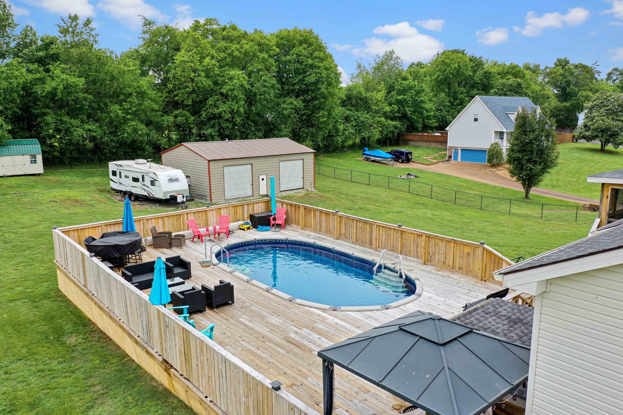 607 Vaughan's Gap Road Spring Hill, TN 37174 - Photo 34 of 34 a view of a chairs and table in the backyard with a garden