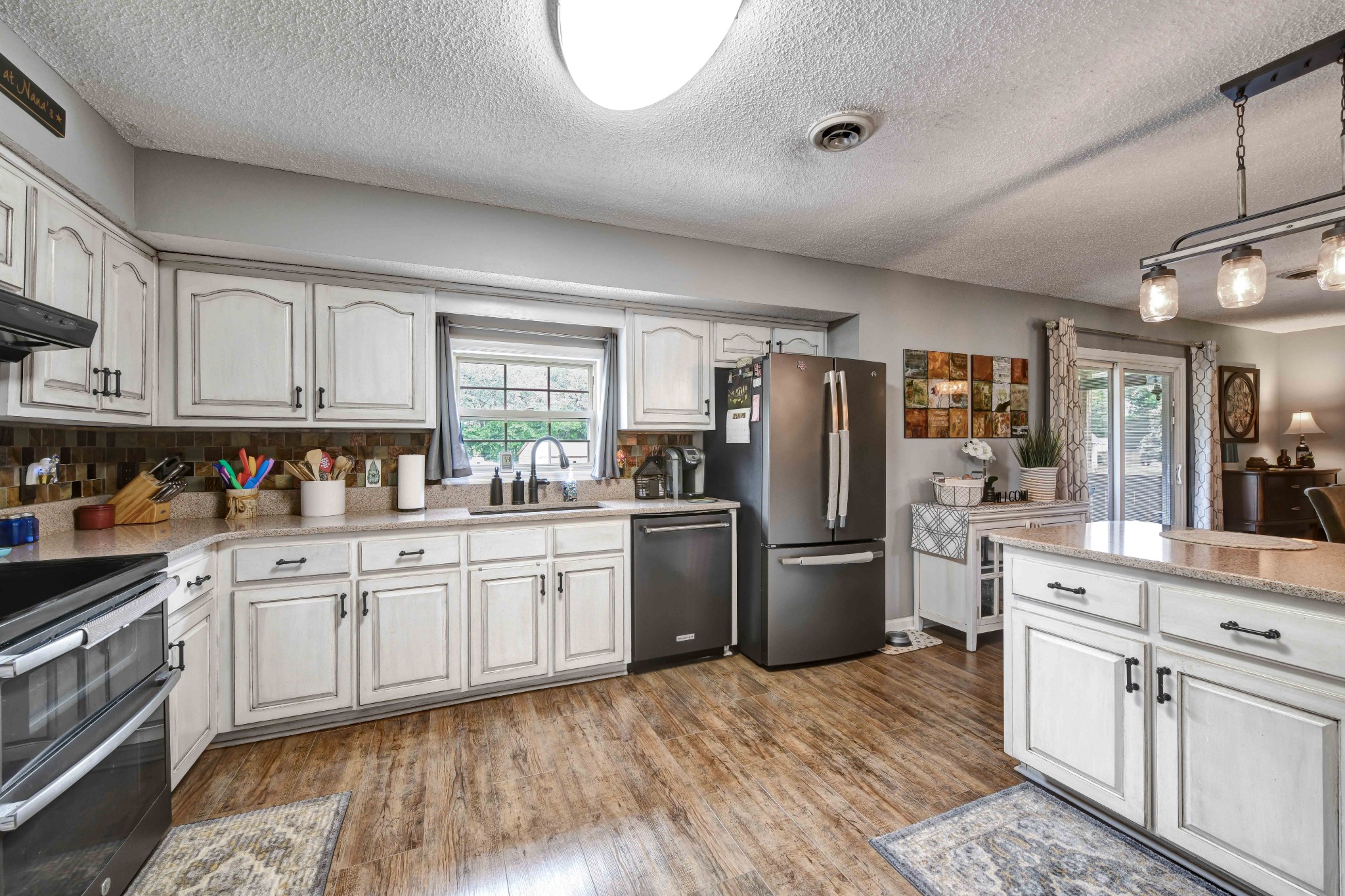 607 Vaughan's Gap Road Spring Hill, TN 37174 - Photo 9 of 34 a kitchen with a sink stainless steel appliances and cabinets