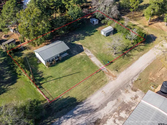 an aerial view of a house with a yard