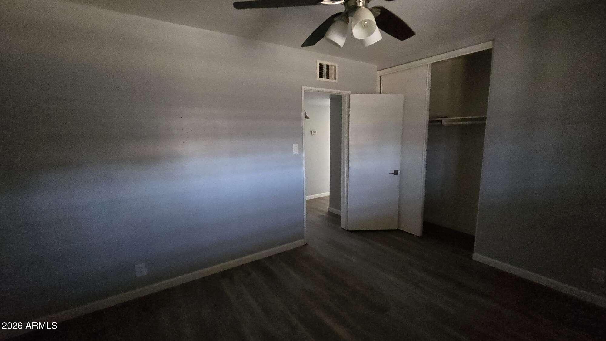 834 West Osborn Road Phoenix, AZ 85013 - Photo 25 of 45 an empty room with wooden floor fan and window