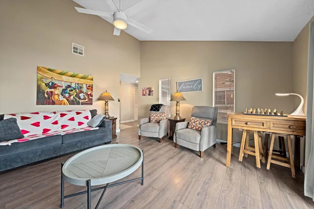 a living room with furniture and a wooden floor