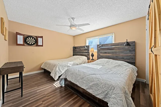 a bedroom with bed and wooden floor