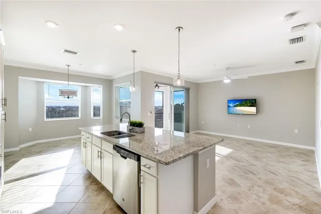 a kitchen with granite countertop a sink cabinets and window