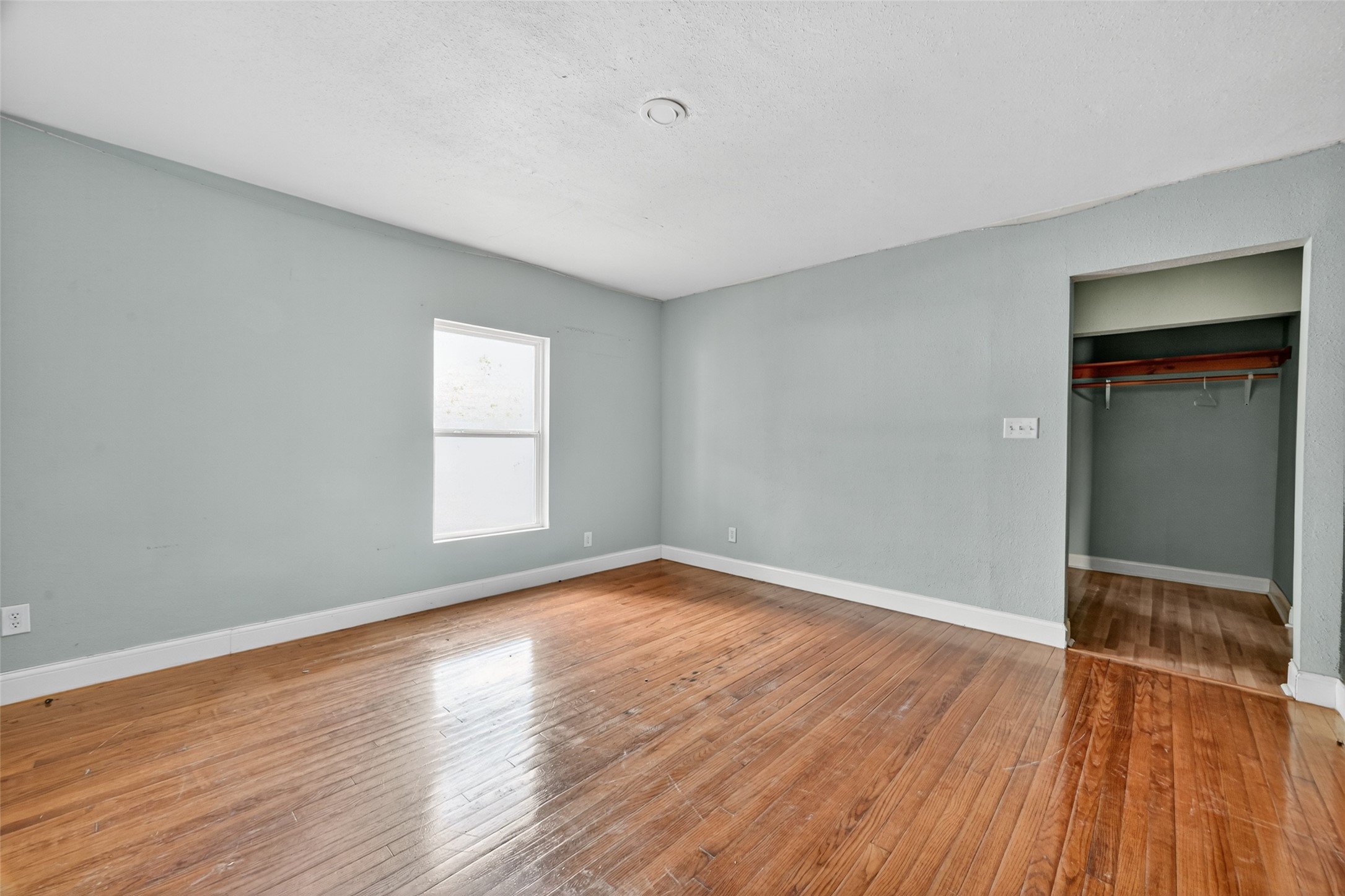 6434 Boothline Road Richmond, TX 77469 - Photo 21 of 36 an empty room with wooden floor and windows