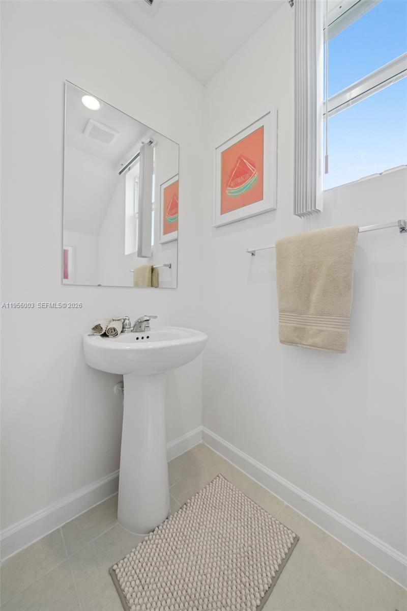 19448 Southwest 338th Terrace Homestead, FL 33034 - Photo 19 of 44 a bathroom with a sink a mirror and vanity