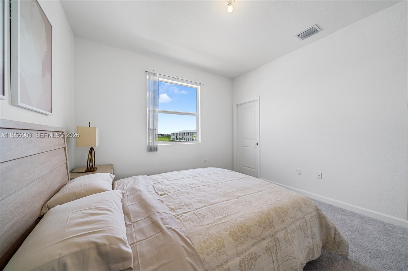 19448 Southwest 338th Terrace Homestead, FL 33034 - Photo 26 of 44 a bedroom with a bed and a window