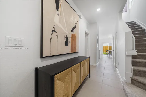 a view of a hallway with wooden floor and staircase