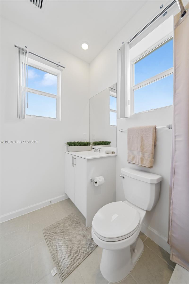 19448 Southwest 338th Terrace Homestead, FL 33034 - Photo 31 of 44 a white toilet sitting next to a bathroom sink