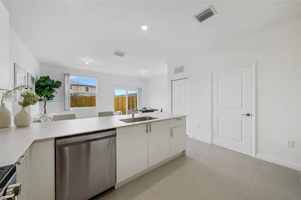 a kitchen with a refrigerator stove and microwave