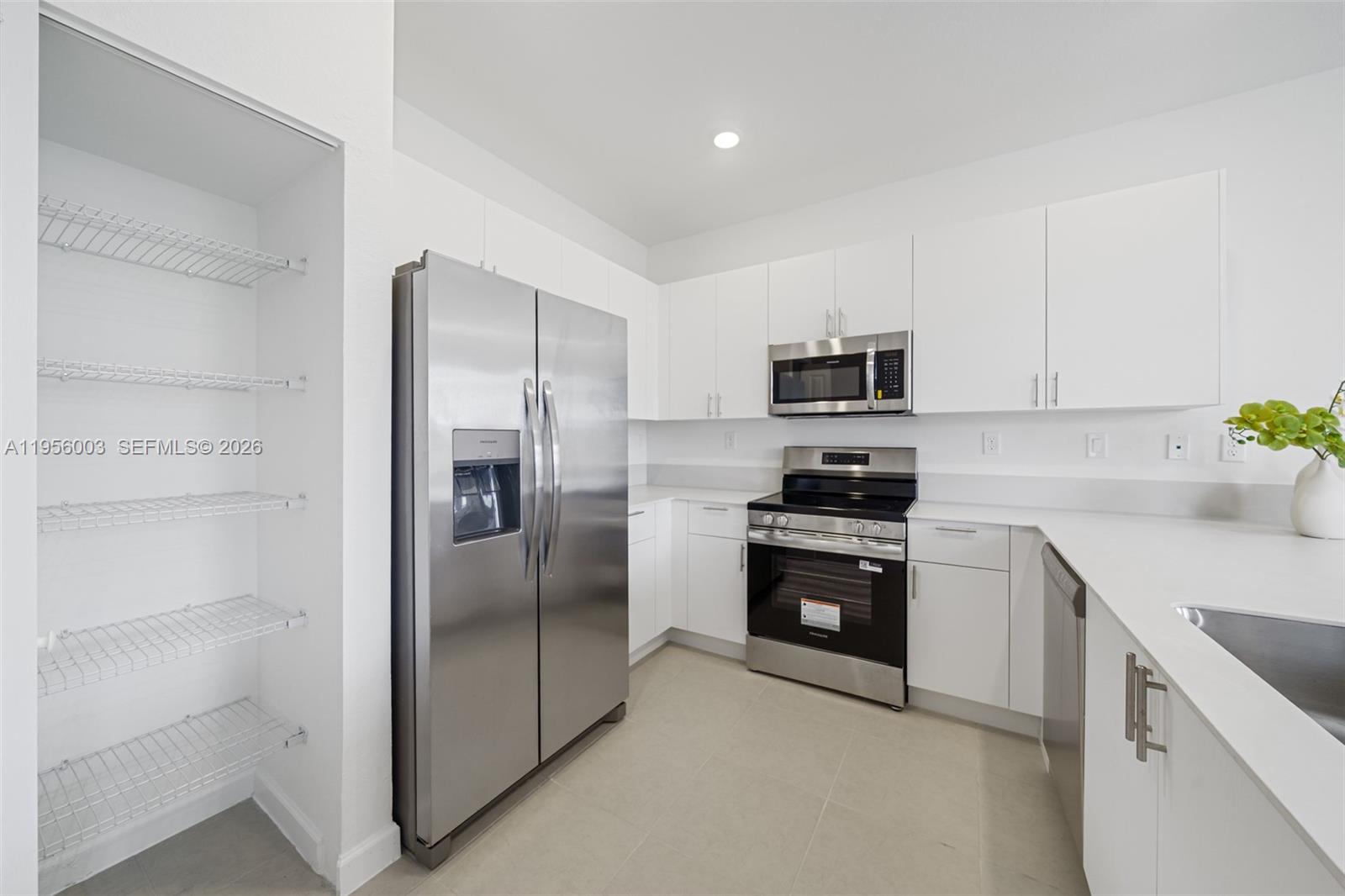 19448 Southwest 338th Terrace Homestead, FL 33034 - Photo 10 of 44 a kitchen with a refrigerator stove and microwave