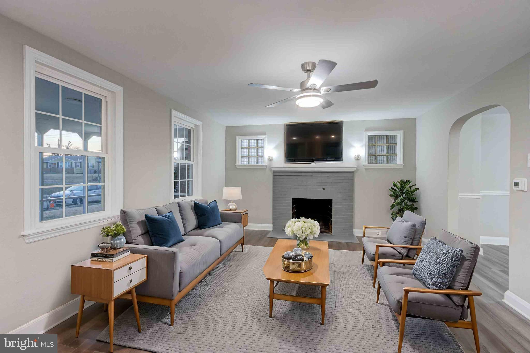 1202 Circle Drive Halethorpe, MD 21227 - Photo 2 of 36 a living room with furniture a fireplace and a flat screen tv