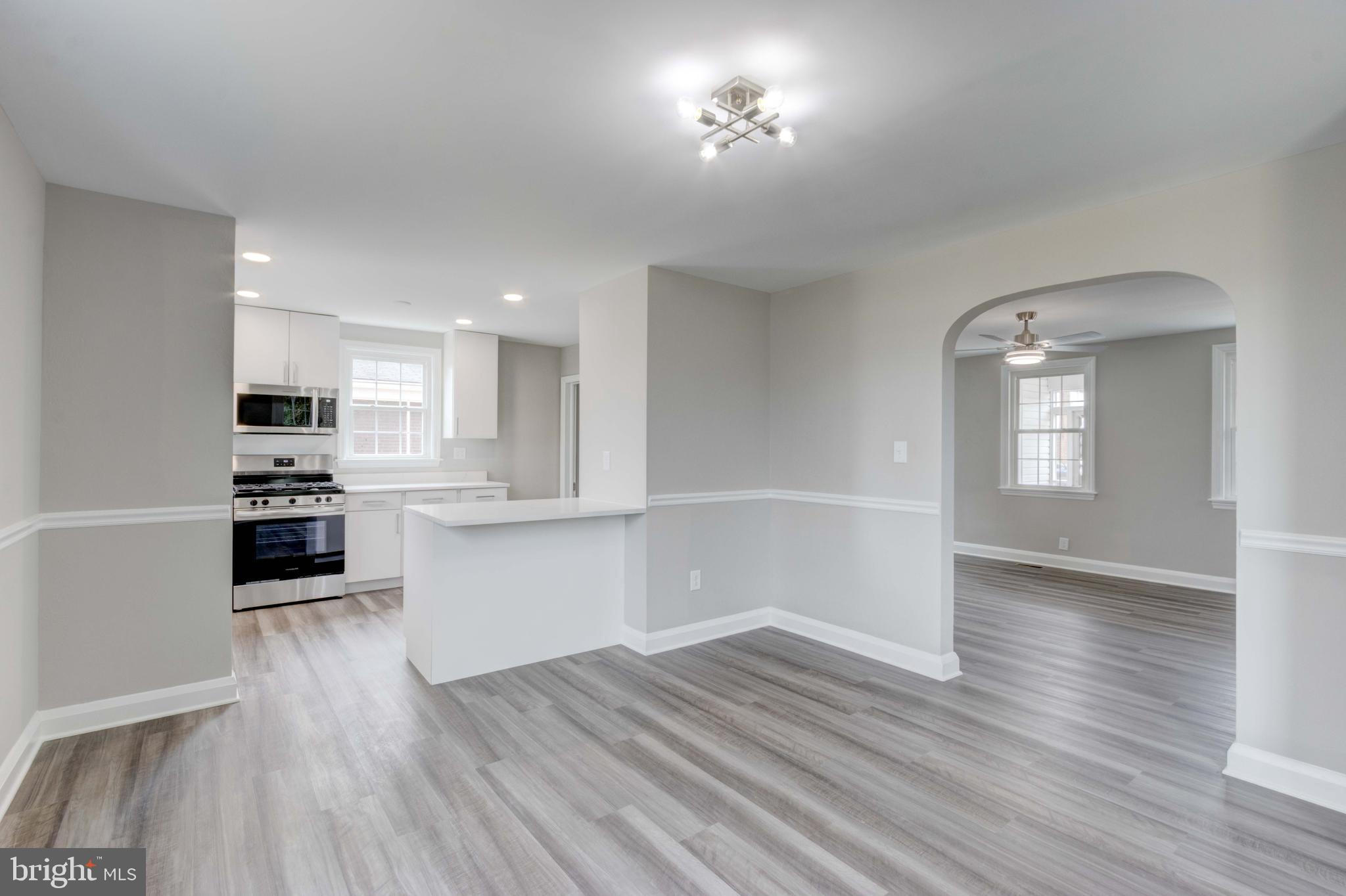 1202 Circle Drive Halethorpe, MD 21227 - Photo 23 of 36 a kitchen with a wooden floor a window and appliances