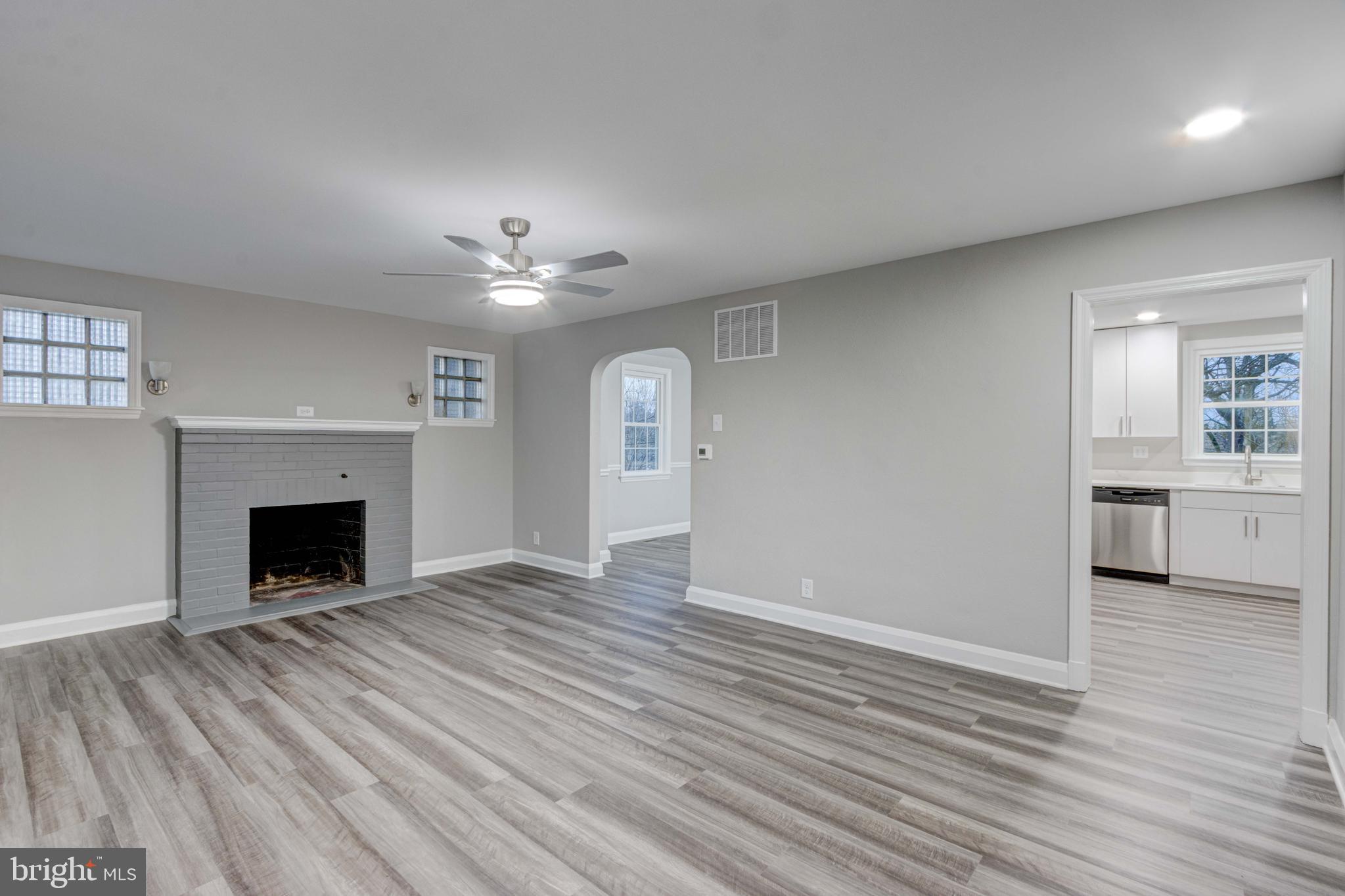 1202 Circle Drive Halethorpe, MD 21227 - Photo 6 of 36 an empty room with windows and a fireplace