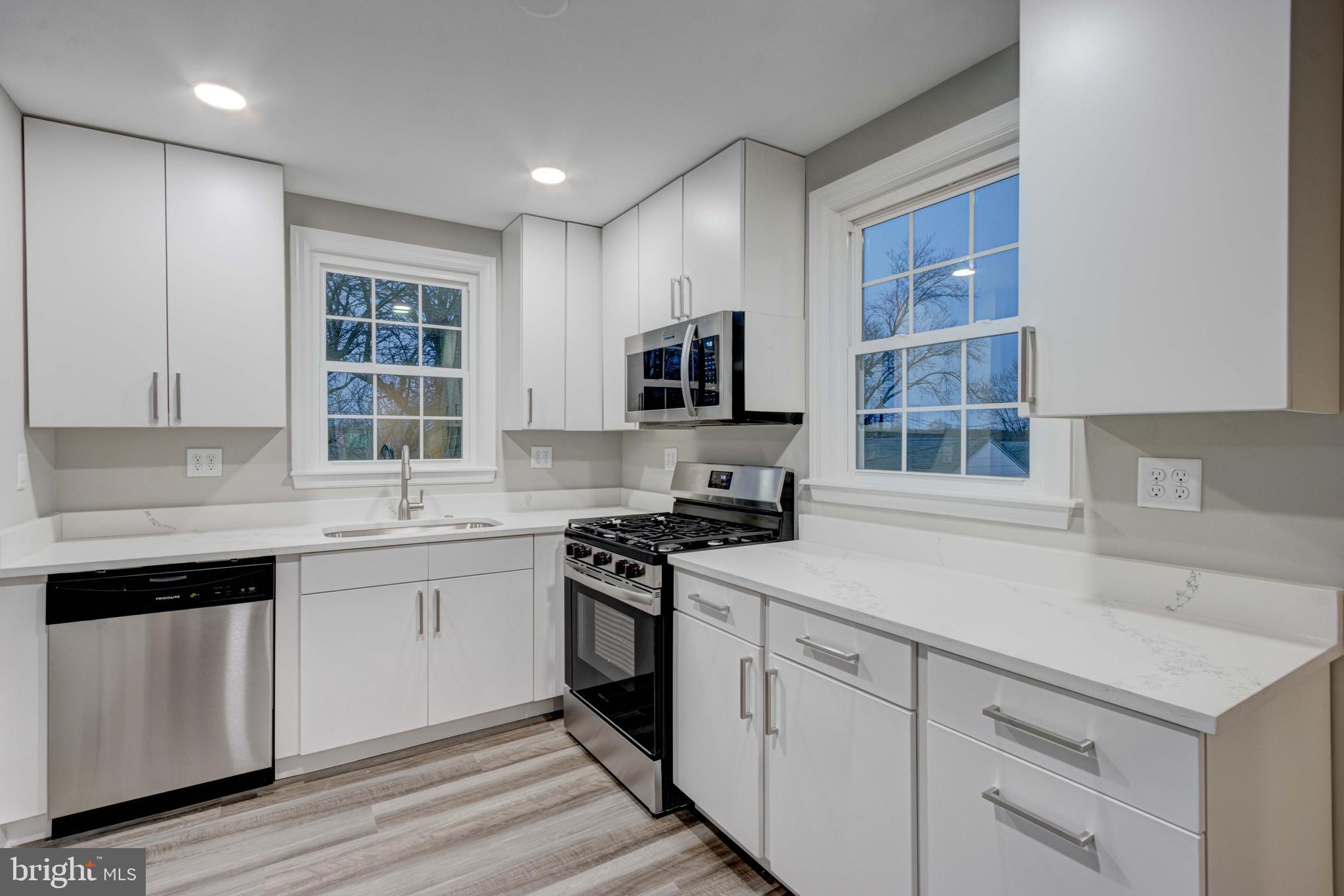 1202 Circle Drive Halethorpe, MD 21227 - Photo 10 of 36 a kitchen with cabinets appliances a sink and a window