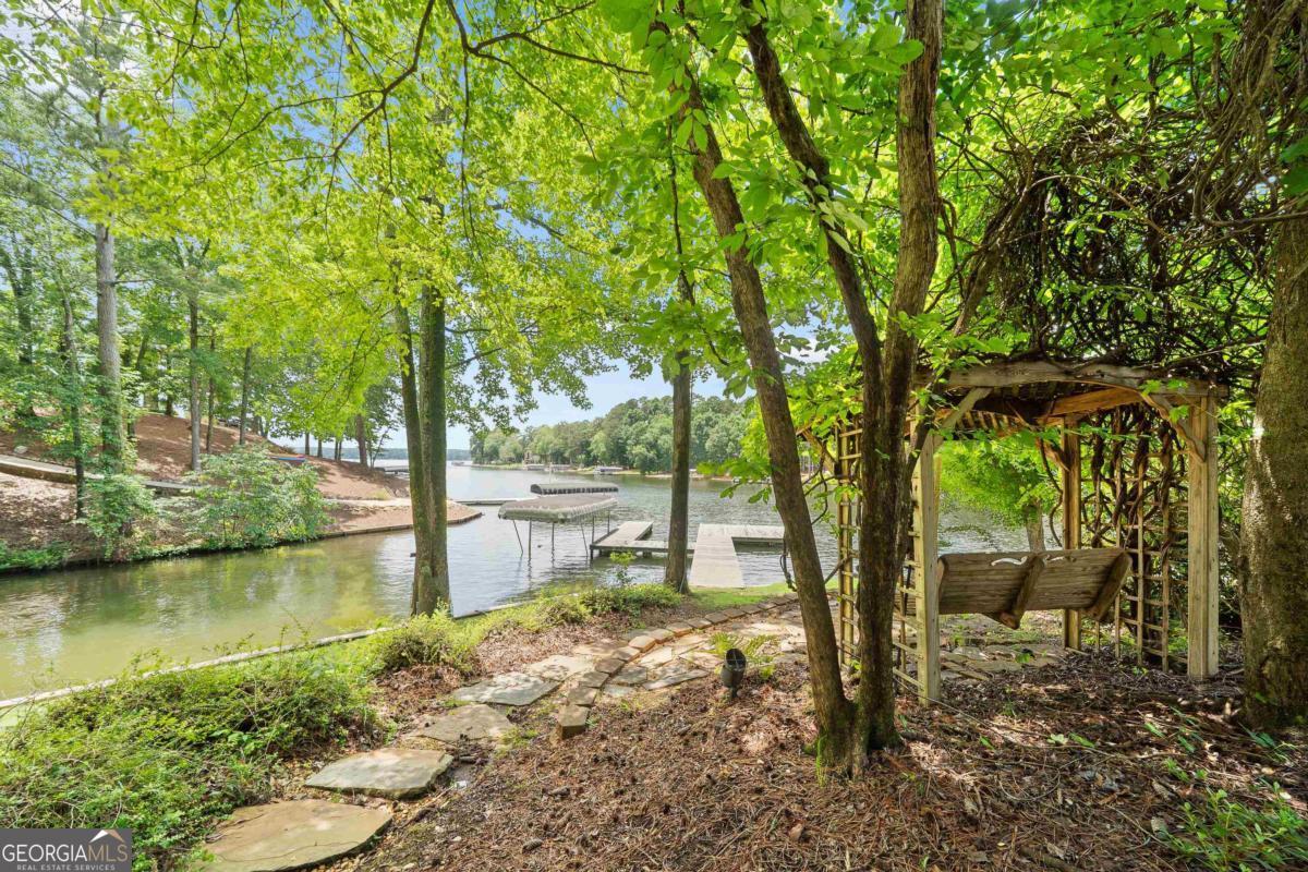 1031 Old Still Road Greensboro, GA 30642 - Photo 70 of 73 a backyard of a house with lots of green space and fountain