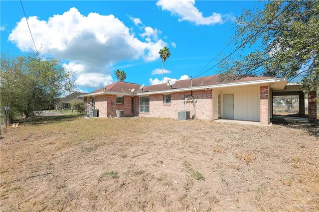 a white house with a large tree in front of it