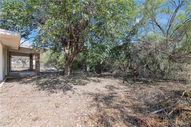 a view of a house with a tree in the background