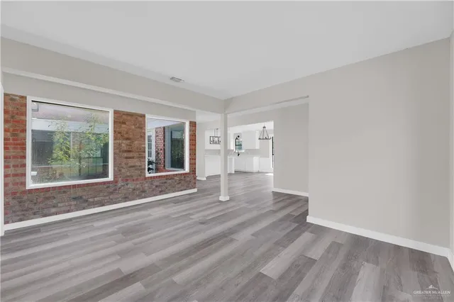 a view of wooden floor and windows in a room