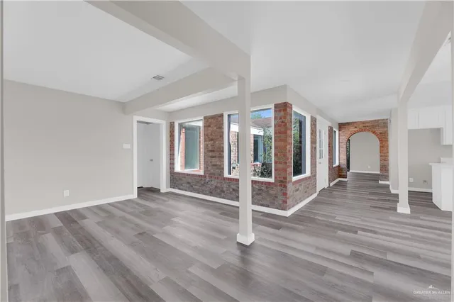 a view of a livingroom with wooden floor and entryway