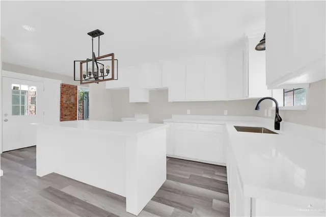 a kitchen with a sink a faucet appliances and cabinets