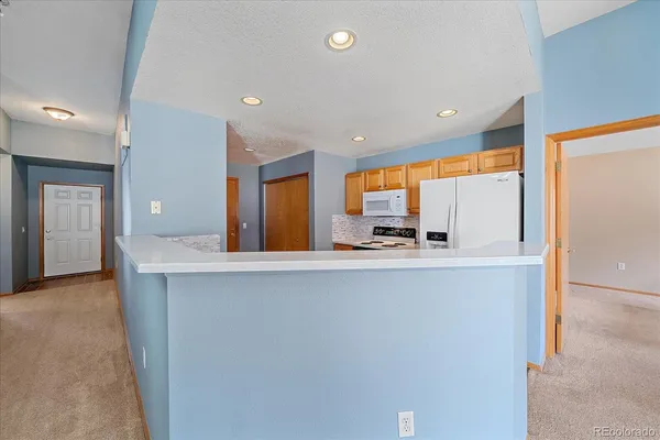 a kitchen with stainless steel appliances a large window