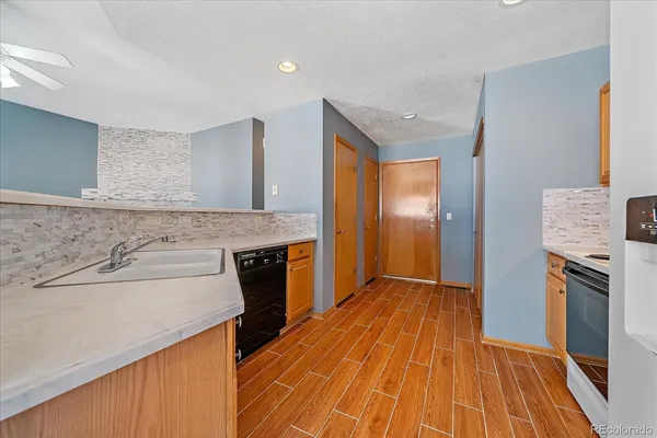a view of a kitchen cabinets a sink and wooden floor