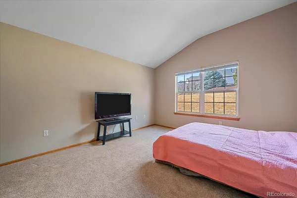 a bedroom with a bed chair and window