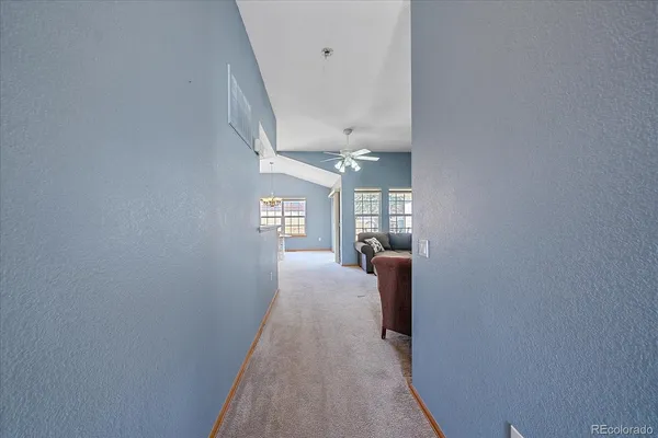 a view of a hallway with windows and stairs