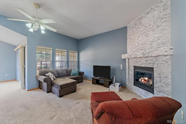 a living room with furniture and a fireplace
