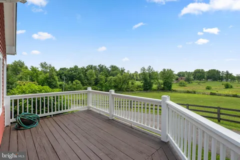 a view of a patio with a table and chairs and potted plants