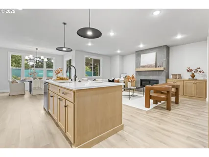 a kitchen with stainless steel appliances kitchen island granite countertop a sink and cabinets