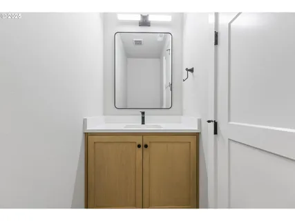 a bathroom with a sink vanity and a mirror