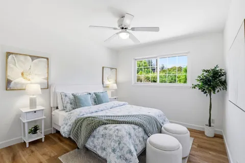 a bedroom with a bed and a potted plant