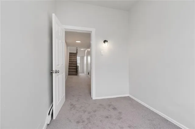 a view of a hallway with wooden shelves