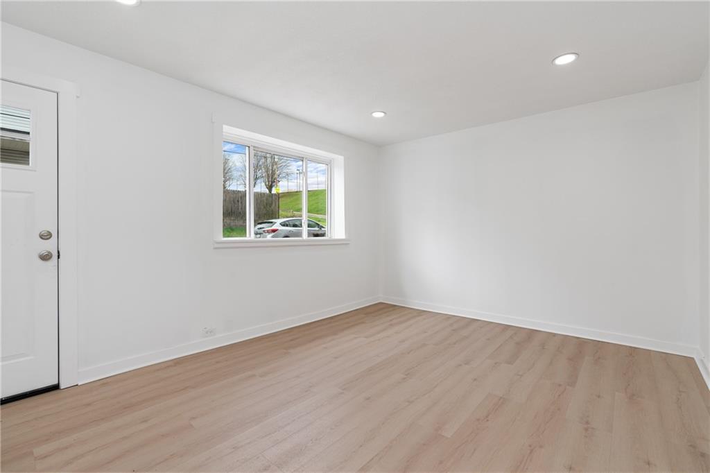 2307 Salisbury Street Pittsburgh, PA 15210 - Photo 3 of 24 a view of an empty room with wooden floor and a window