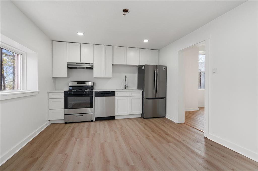 2307 Salisbury Street Pittsburgh, PA 15210 - Photo 6 of 24 a kitchen with a refrigerator and a stove top oven
