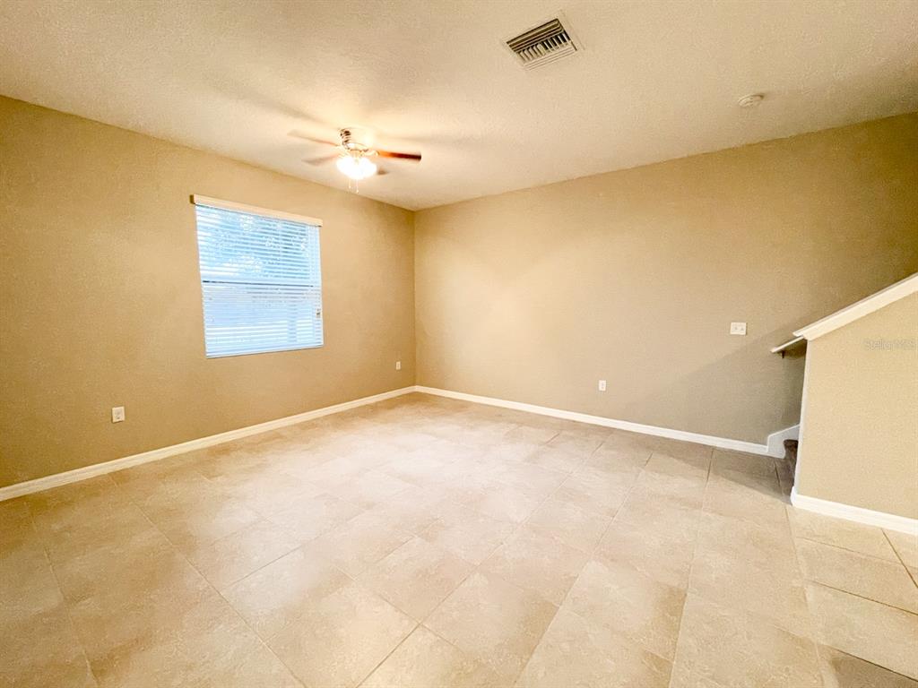 27023 Juniper Bay Drive Wesley Chapel, FL 33544 - Photo 5 of 13 an empty room with a empty space and windows