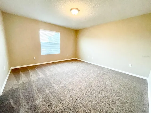 an empty room with a empty space and a window