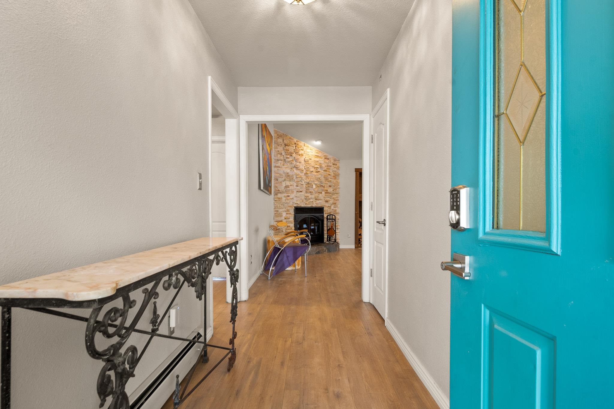 398 Butte Court Grand Junction, CO 81507 - Photo 4 of 33 a view of a hallway with wooden floor and staircase