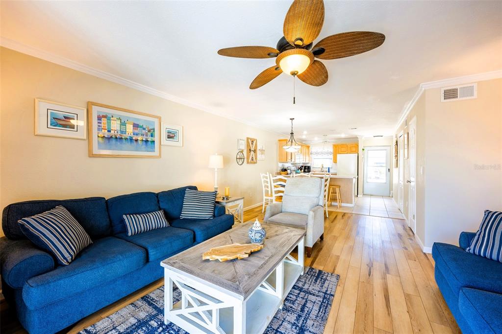 6777 Winkler Road, Unit 150 Fort Myers, FL 33919 - Photo 16 of 48 a living room with furniture and wooden floor