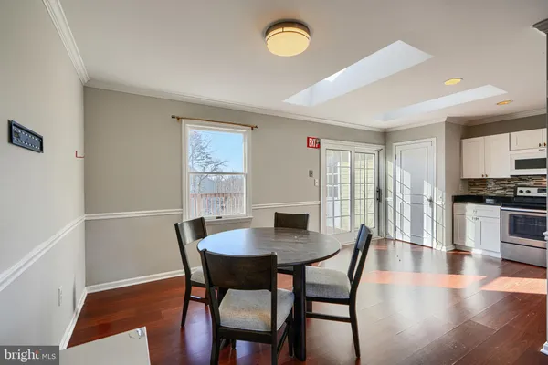 a kitchen with stainless steel appliances granite countertop a refrigerator a stove a sink and a microwave