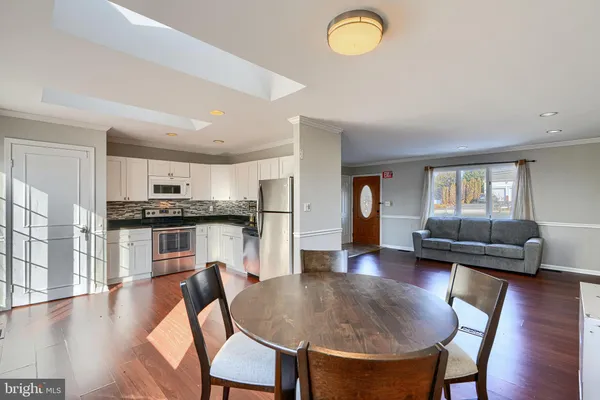 a kitchen with stainless steel appliances granite countertop a refrigerator stove a sink and a microwave