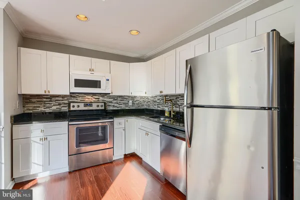 a view of an entryway with wooden floor