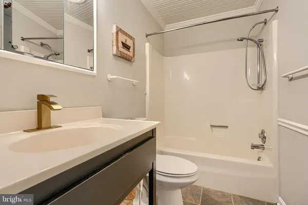a view of a hallway with wooden floor and front door